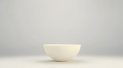 Simple white bowl placed on a smooth surface with a minimalistic background