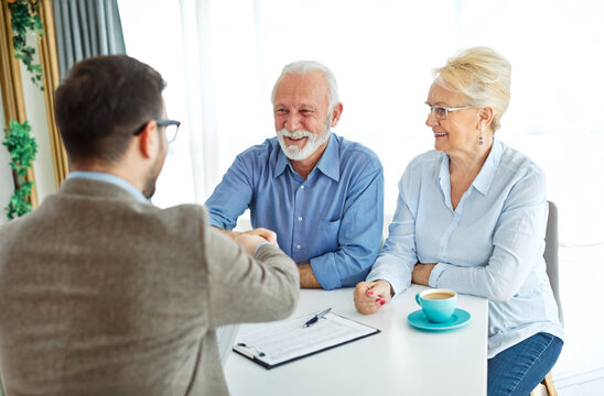 meeting agreement investment couple contract handshake advice retirement consultation senior elderly document deal insurance finance signing