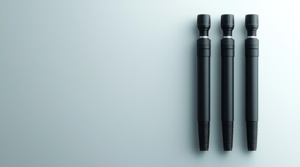 Fototapeta premium Three black pens on grey background, minimalist design, product photography