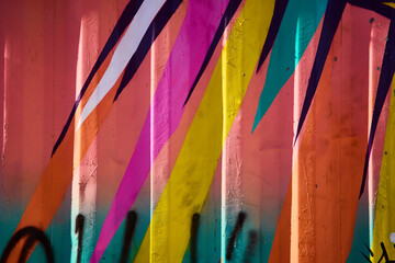 Vibrant Geometric Street Art on Corrugated Metal with Textured Depth