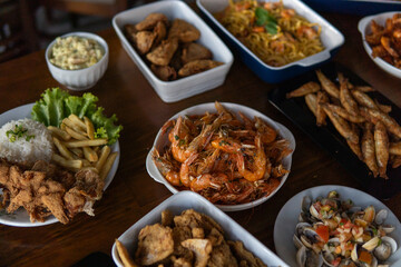 Various dishes with shrimp and seafood served on a table