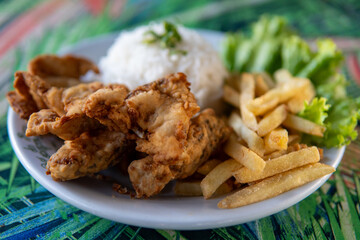 Brazilian dish made of fish with rice and fries