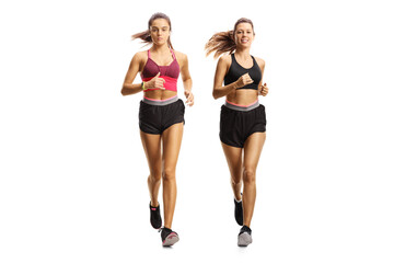 Two young women jogging together side by side