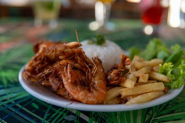 Brazilian dish made with garlic and oil shrimp with rice and potatoes, everyday food