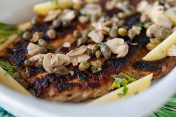 Baked fish with mushrooms and capers