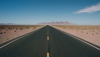 Naklejka premium Endless Desert Highway Stretching into the Horizon Under a Vast Blue Sky