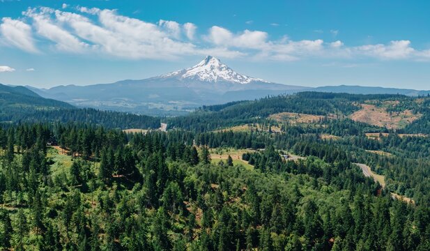 Panoramic view of Mount Hood, Oregon, with lush green forests and a highway winding through the valley below. A beautiful summer day. , Odell, Oregon, United States