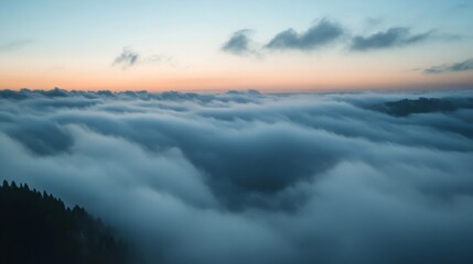 Obraz premium Aerial View of a Serene Landscape at Sunset with Soft Pink and Orange Clouds Over a Misty Valley
