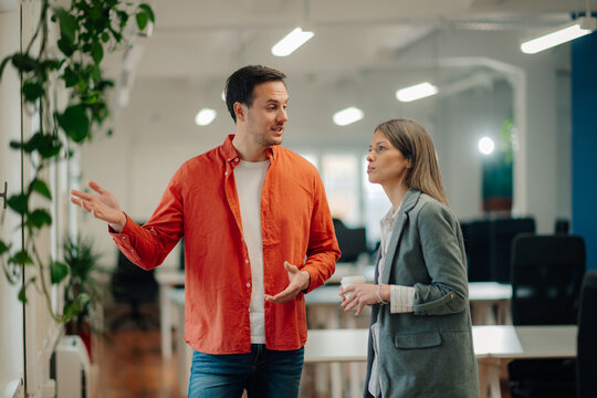 Two business colleagues discussing strategy in modern office