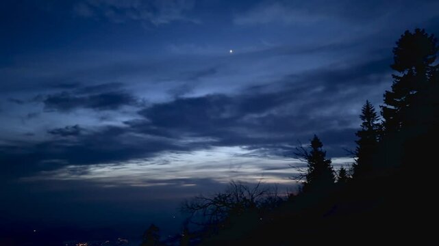 Illuminated tower on top of mountain, burning night sky. High quality 4k footage