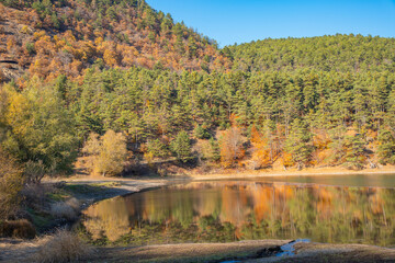 Autumn landscape at Boraboy Lake Nature Park with forested hills and reflections. Beautiful seasonal change with fall colors at Lake Boraboy