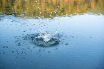 Water drops splash, ripples and bubbles effect. Water splash and ripples on blue sea texture pattern background. Liquid motion on calm lake surface. Ring affect, circles, round droplets 