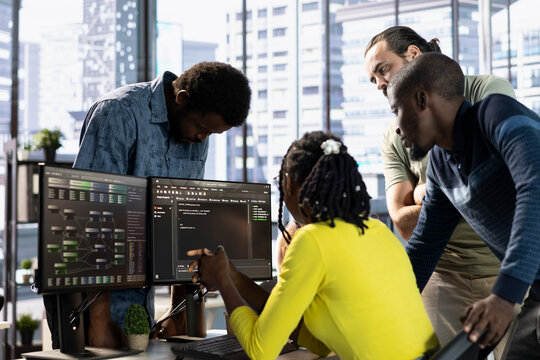 Teamworking colleagues testing machine learning company software to minimize occurrence of bugs, identifying bottlenecks. Coworkers doing brainstorming, writing clean, efficient code to reduce errors