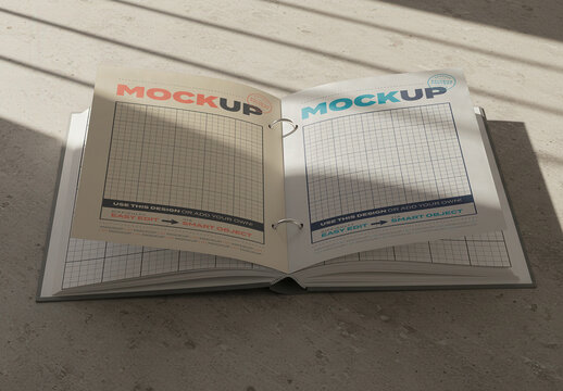 Folder Open Pages on Concrete Floor with Sunlight Mockup