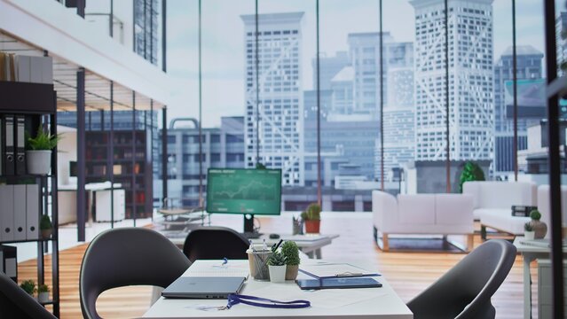 Empty modern office workspace designed for job interviews to achieve business success, professionals using advanced technology for resumes selection during recruitment process.