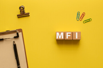 There is wood cube with the word MFI. It is an abbreviation for Mobile First Index as eye-catching...