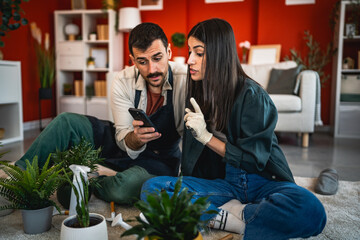 couple browse internet about gardening and take care of other plants