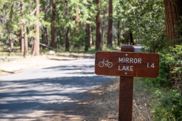 A wooden trail sign pointing to Mirror Lake, Yosemite National Park, California, USA, May 29, 2022.
