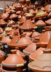 Fototapeta premium A set of tagines of many types displayed in street stalls in the souk for sale.