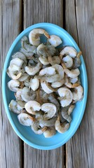 Fototapeta premium Fresh Shrimp on Blue Plate Seafood Dish Overhead