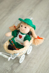 Traditional Folk Art Rag Doll with Green Dress in Vintage White Wicker Pram