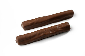 Delightful chocolate sticks arranged elegantly on a white background showcasing their smooth texture and rich color