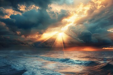 Sunlight breaks through dark clouds over ocean waves at sunset creating a breathtaking seascape view