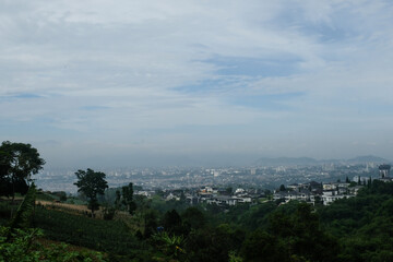 Bandung, Indonesia. Steep slopes on the plateau are filled with real estate and villas. Panoramic landscape. Elite housing built on the hilltop. Housing industry. Copy space