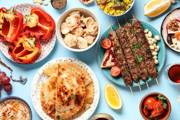 Traditional Eastern dishes on blue background, closeup. Ramadan celebration