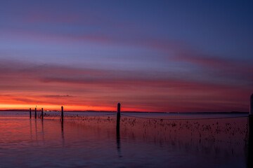 Beautiful dawn colors and clouds over a bay