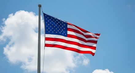 American Flag Waving Proudly Against a Blue Sky with White Clouds