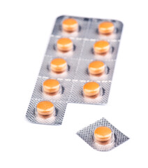 Orange tablets in blister pack arranged neatly on a white background for easy viewing