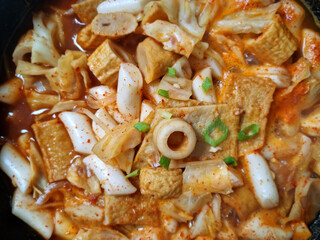 This is Korean style tteokbokki being boiled in a pot.	
