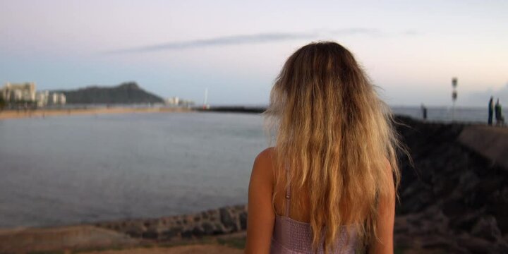 A woman watching volcano crater in hawaii, anamorphic lens
