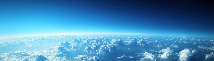Fototapeta premium A breathtaking aerial view showcasing a vibrant blue sky adorned with fluffy white clouds scattered throughout.