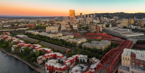 Obraz premium Aerial view of Portland, OR skyline at sunset. Urban sprawl, bridges, and modern architecture. Broadway Bridge, Portland, Oregon, USA