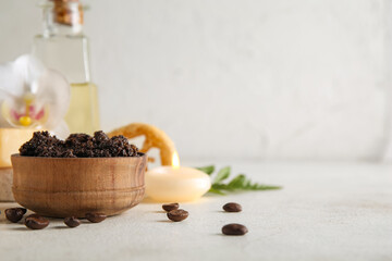 Composition with coffee body scrub and candle on light grunge background