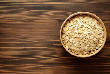 Muesli with oats and dried fruits in a bowl on a white surface