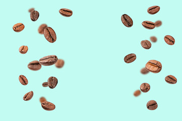 Falling roasted coffee beans on light green background.