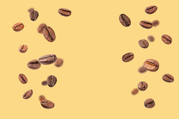 Falling roasted coffee beans on yellow background.