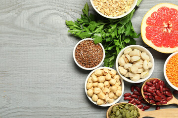 Superfood. Different healthy food products on grey wooden table, flat lay. Space for text