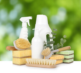 Eco-friendly cleaning products on white table outdoors