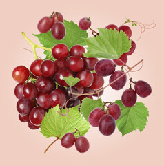 Fresh grapes in air on pink beige background