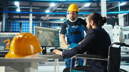 Photovoltaics factory manager with disability in wheelchair gives worker. Solar panels plant supervisor with paraplegia in inclusive workspace talking with employee, camera A - Powered by Adobe