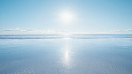 Obraz premium Bright Sunny Day at the Beach: Clear Blue Sky, Calm Ocean Waves, and Sparkling Sand