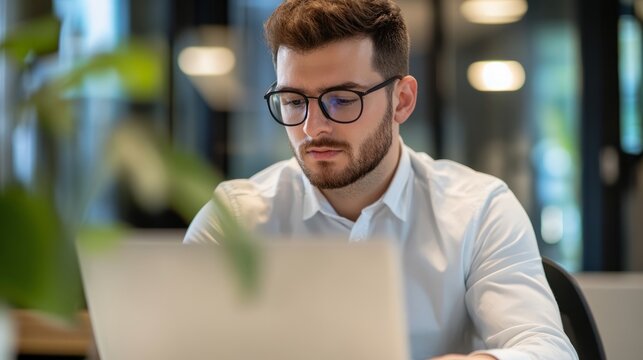Focused businessman working diligently at his desk, embodying professionalism and determination.
