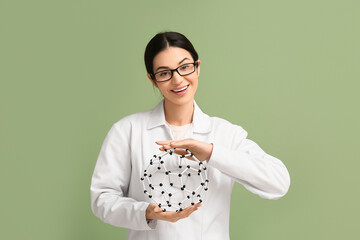 Female inventor with molecular model on green background