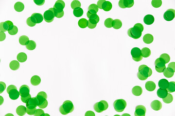 Festive background. Green confetti on a white background, flat lay. Copy space, san patrick day