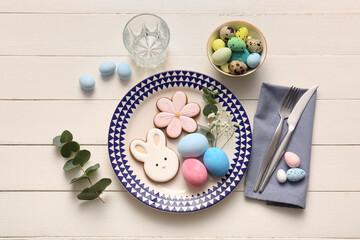 Beautiful table setting with sweet cookies, Easter eggs, eucalyptus branches and gypsophila flowers...