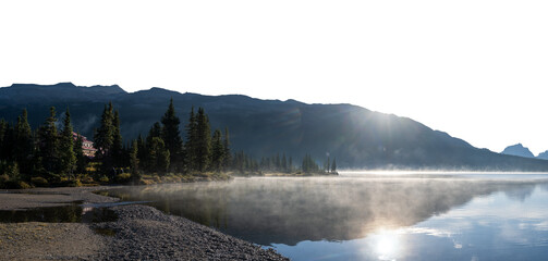A calm mountain lake reflecting rocky range at sunrise with a transparent sky. Panorama
